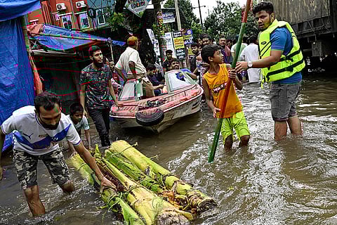 Bangladesh Floods: Volunteers use a boat to help rescue people